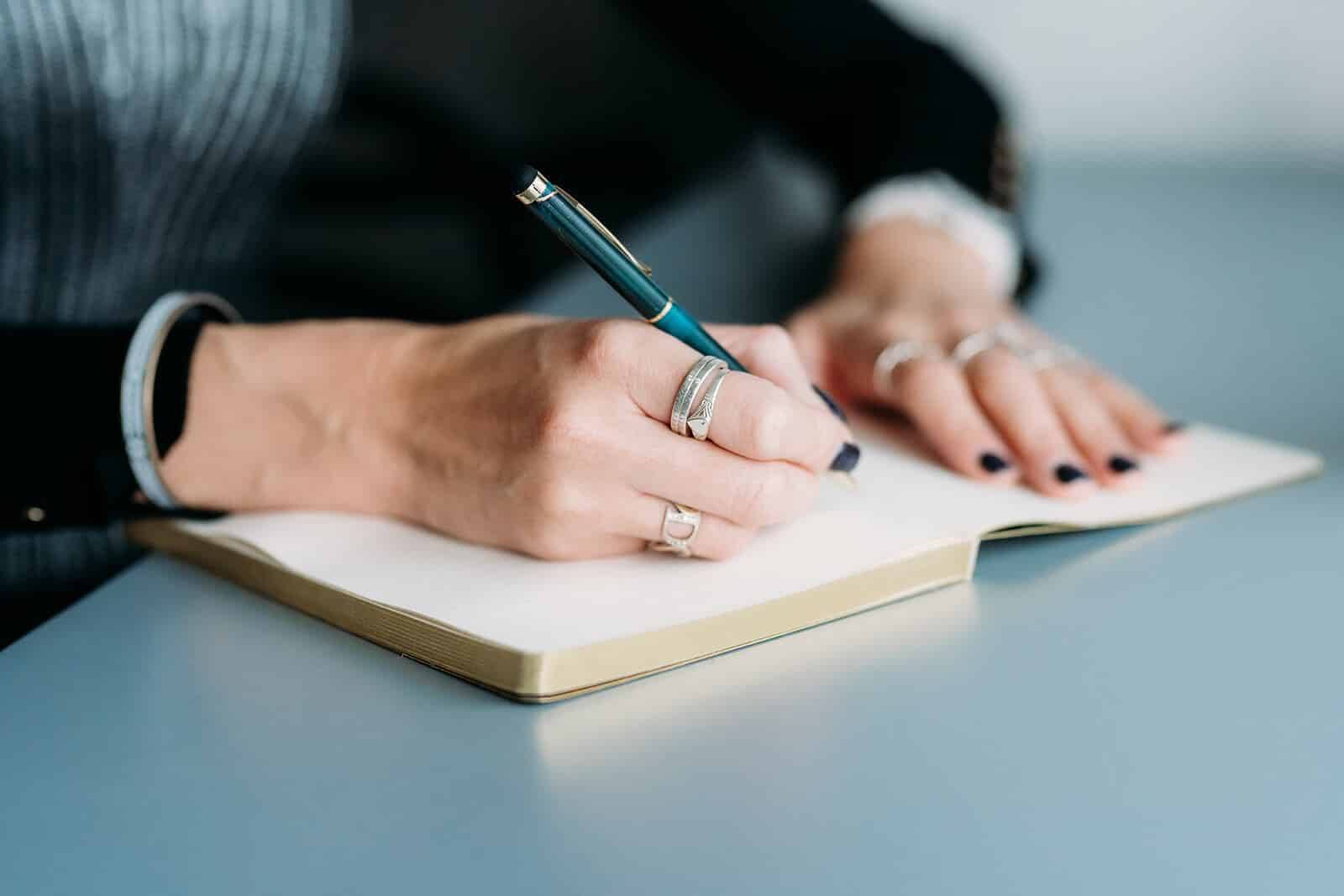 Jo Gee writing notes in her book